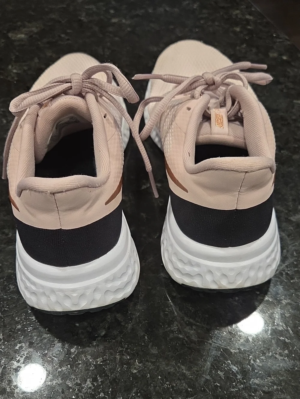 Nike Revolution Women’s Blush Pink Athletic Running Shoes with Rose-Gold Swoosh.